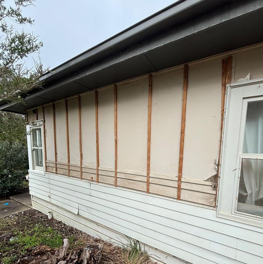 Asbestos fibro cladding concealed behind weatherboards